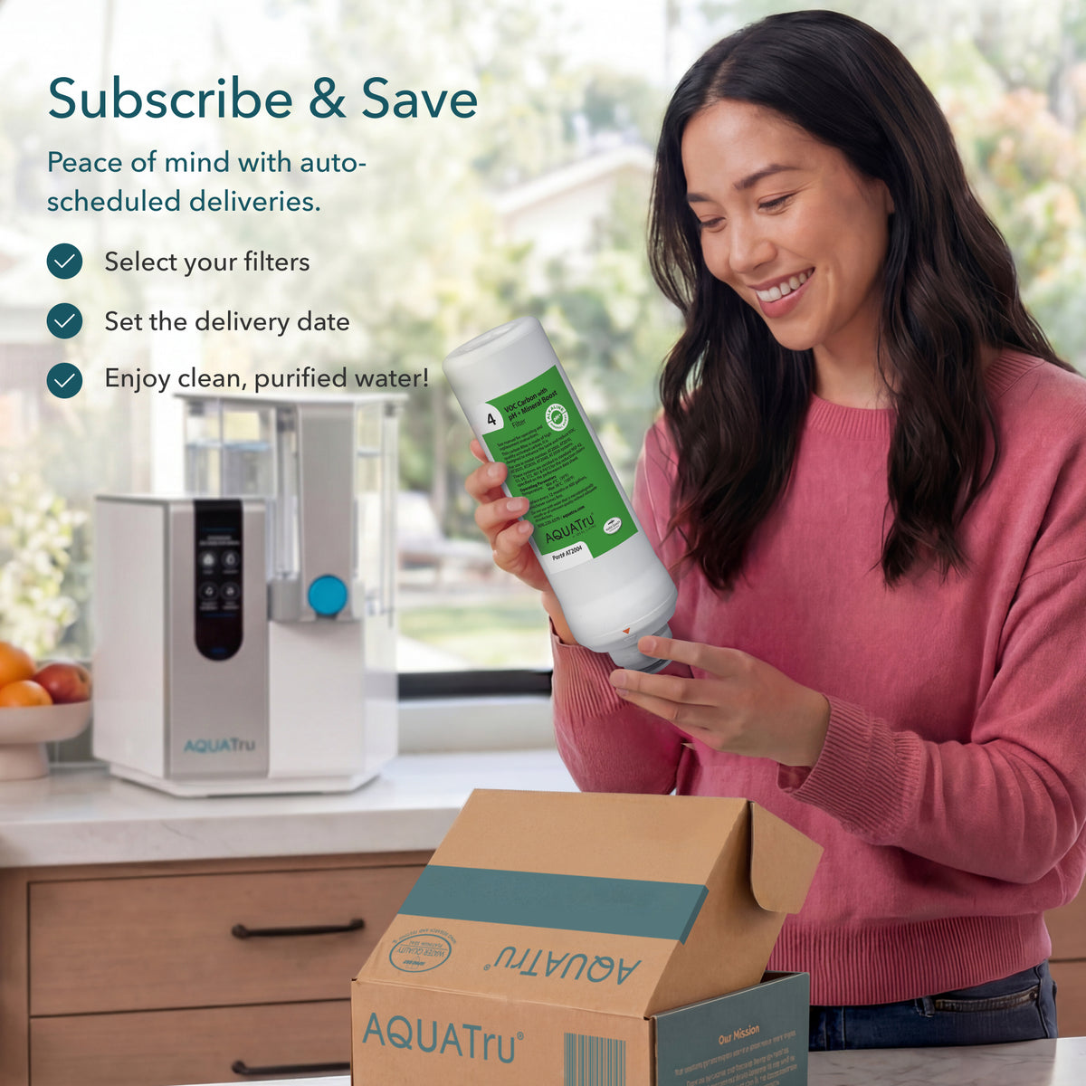 A woman holds a water filter bottle next to an AQUATru water purifier and an open subscription box.