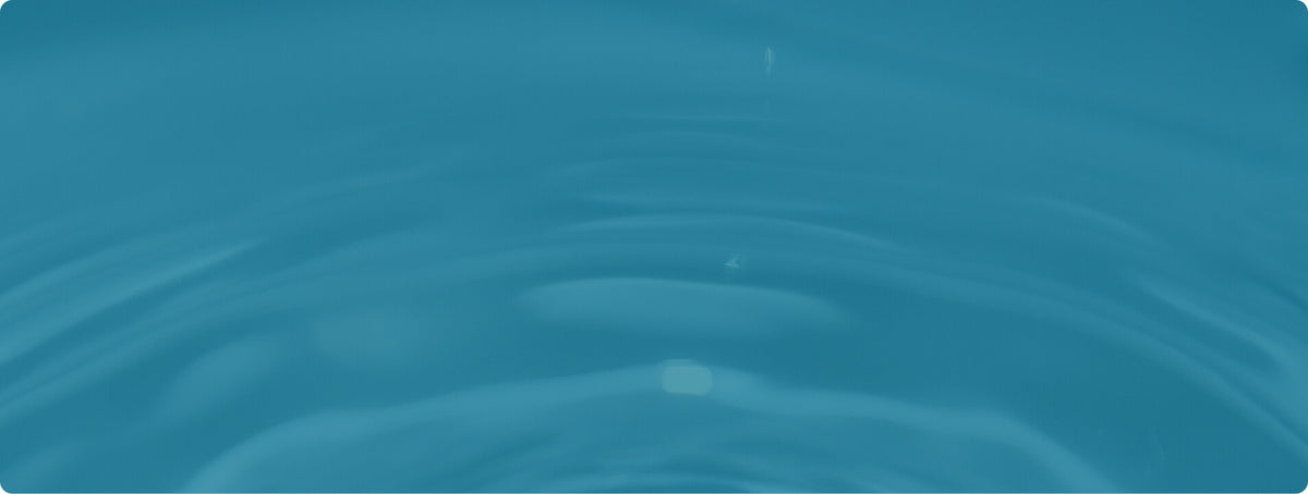 Calm turquoise water surface with gentle ripples and soft reflections.