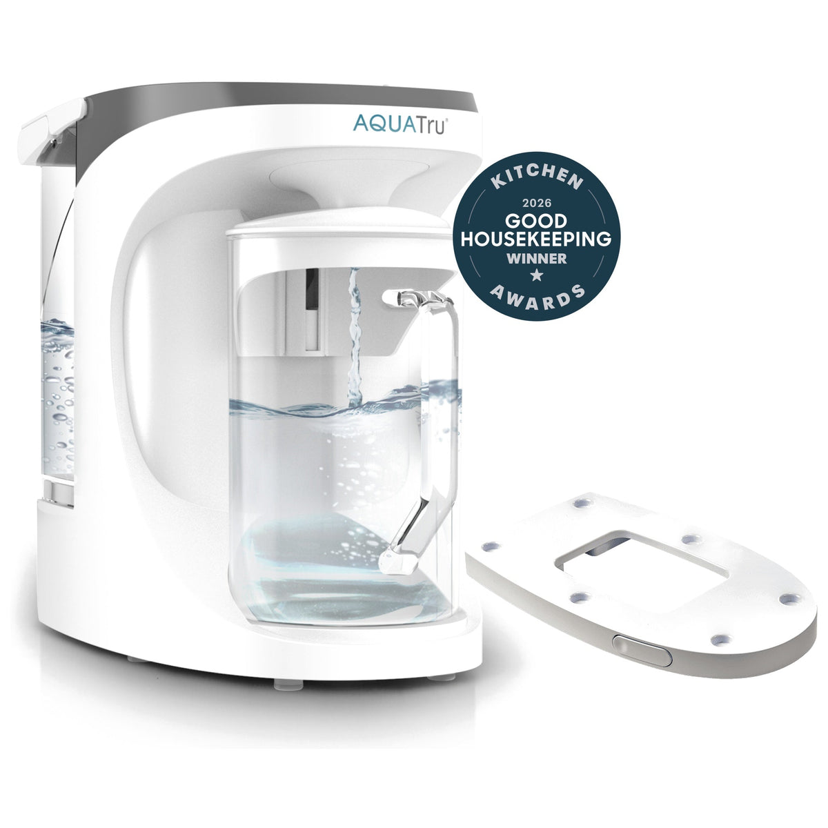 AquaTru carafe with water pouring, accompanied by a sliding tray and a Good Housekeeping award badge.