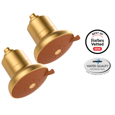 AquaTru Shower 2-Pack in brushed gold: two showerheads with terracotta spray faces, beside Forbes Vetted 2026 and IAPMO Platinum Seal badges