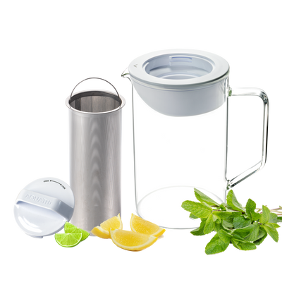 Carafe Tru-Infuser with stainless steel infuser, accompanied by fresh mint, lemon, and lime slices.