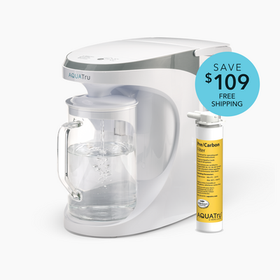 AQUATru water filtration system with a clear carafe and a pre-carbon filter, featuring a promotional tag for savings.