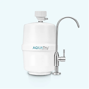 White water filtration system with a sleek silver faucet, designed for countertop use.