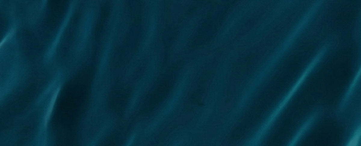Deep teal fabric with soft, flowing waves and subtle sheen.