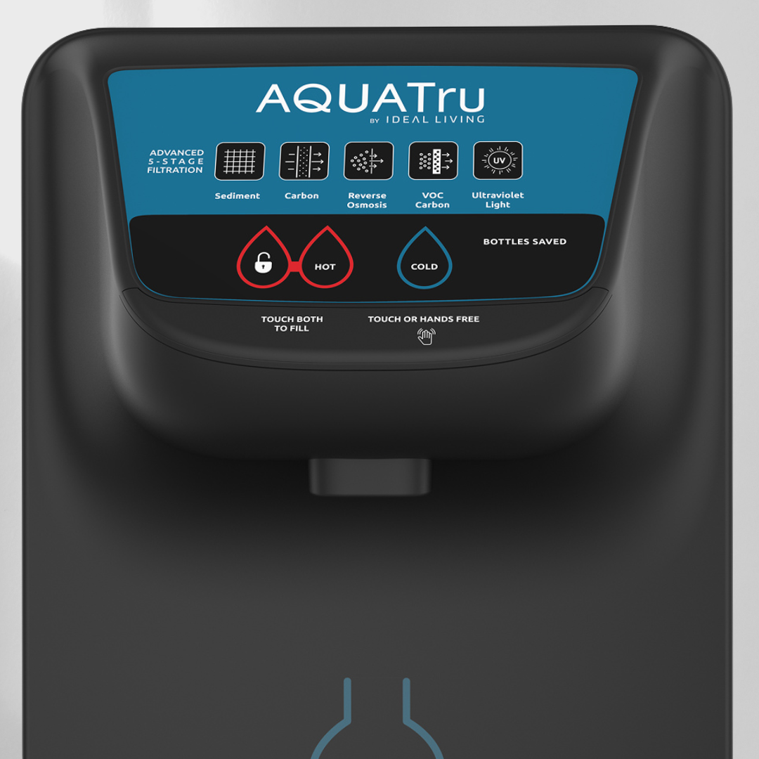Close-up of an AQUATru water filtration system with buttons for hot and cold water, and a digital display.