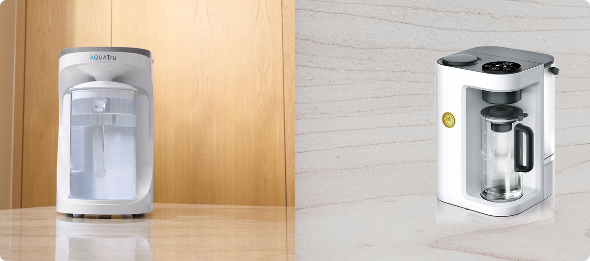 Two water filtration systems side by side on a light-colored surface, one with a sleek design and the other more compact.