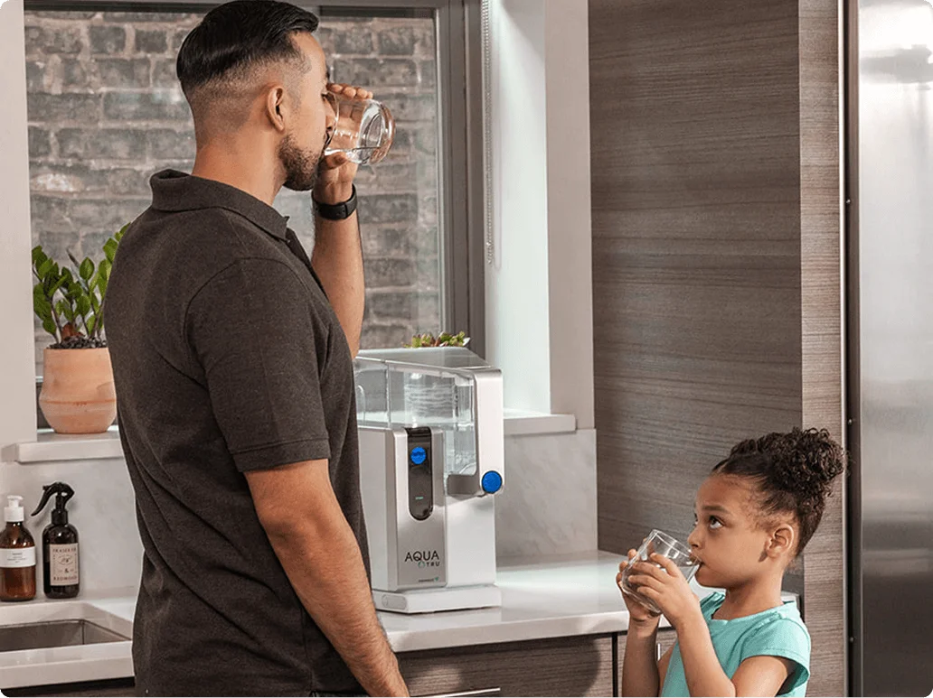 AquaTru founders with an early water purifier
