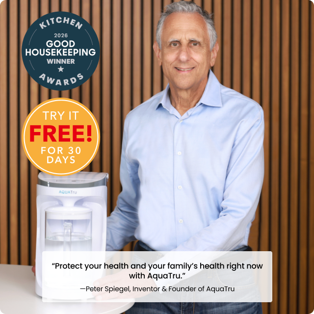 Peter Spiegel stands beside an AquaTru water purifier, promoting a 30-day free trial offer.